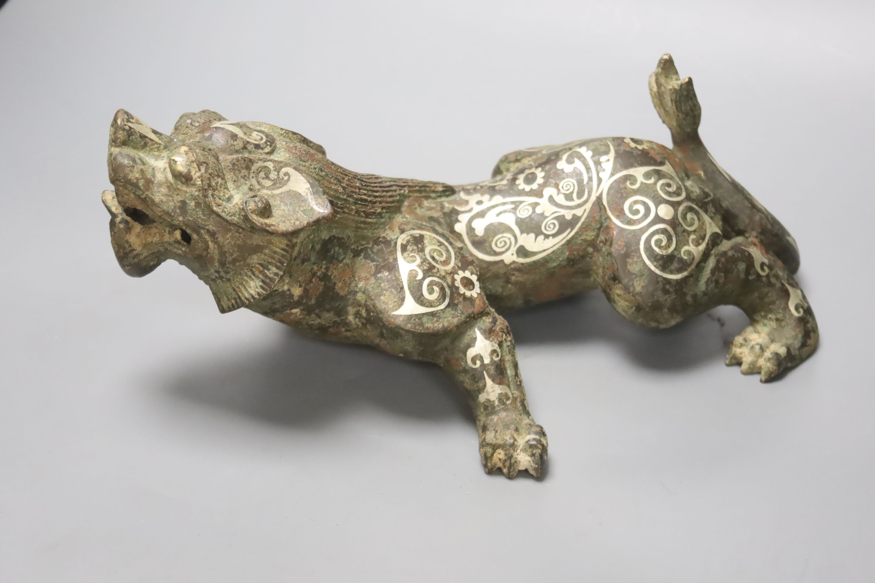 A Chinese inlaid bronze figure of a lion dog, Han dynasty style